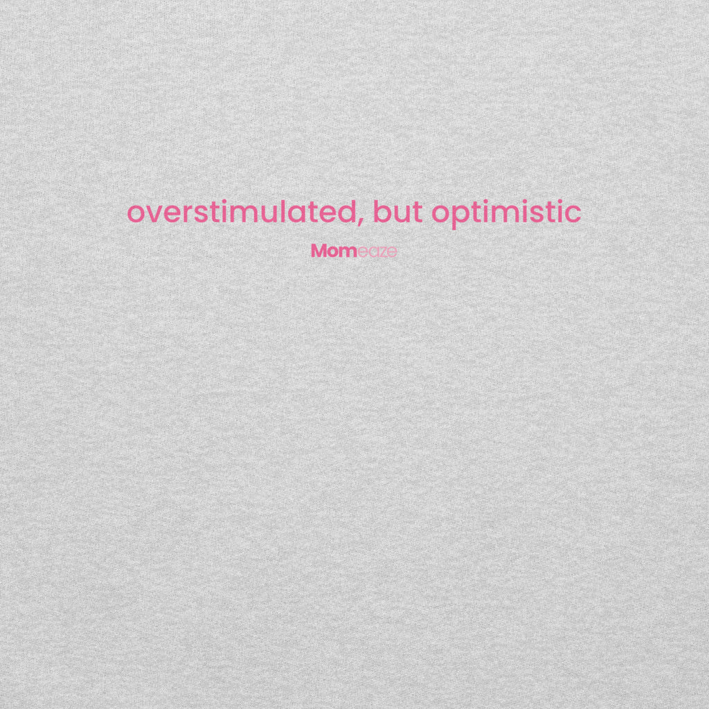 Overstimulated But Optimistic hoodie in heather grey, front view with the phrase printed across the chest